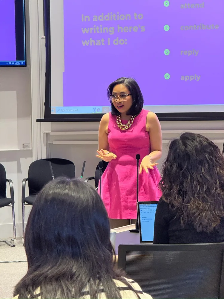 Rebecca presenting in front of a purple slide