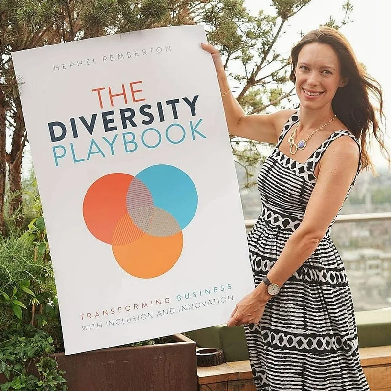 Client holding a poster of The Diversity Playbook