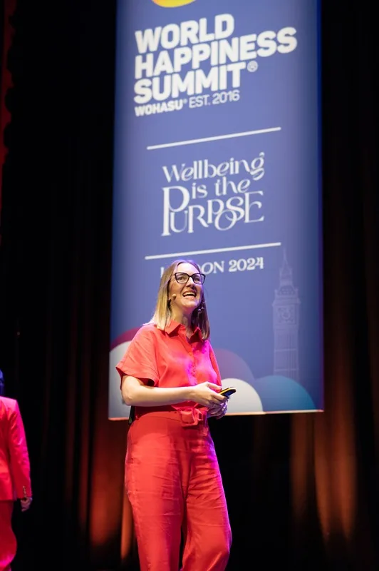 Rebecca on stage at World Happiness Summit