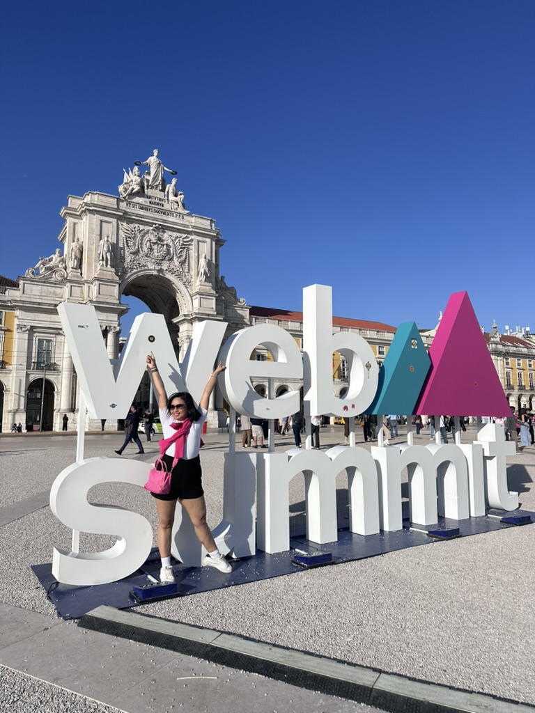 Rebecca Leppard beside the large Web Summit sign