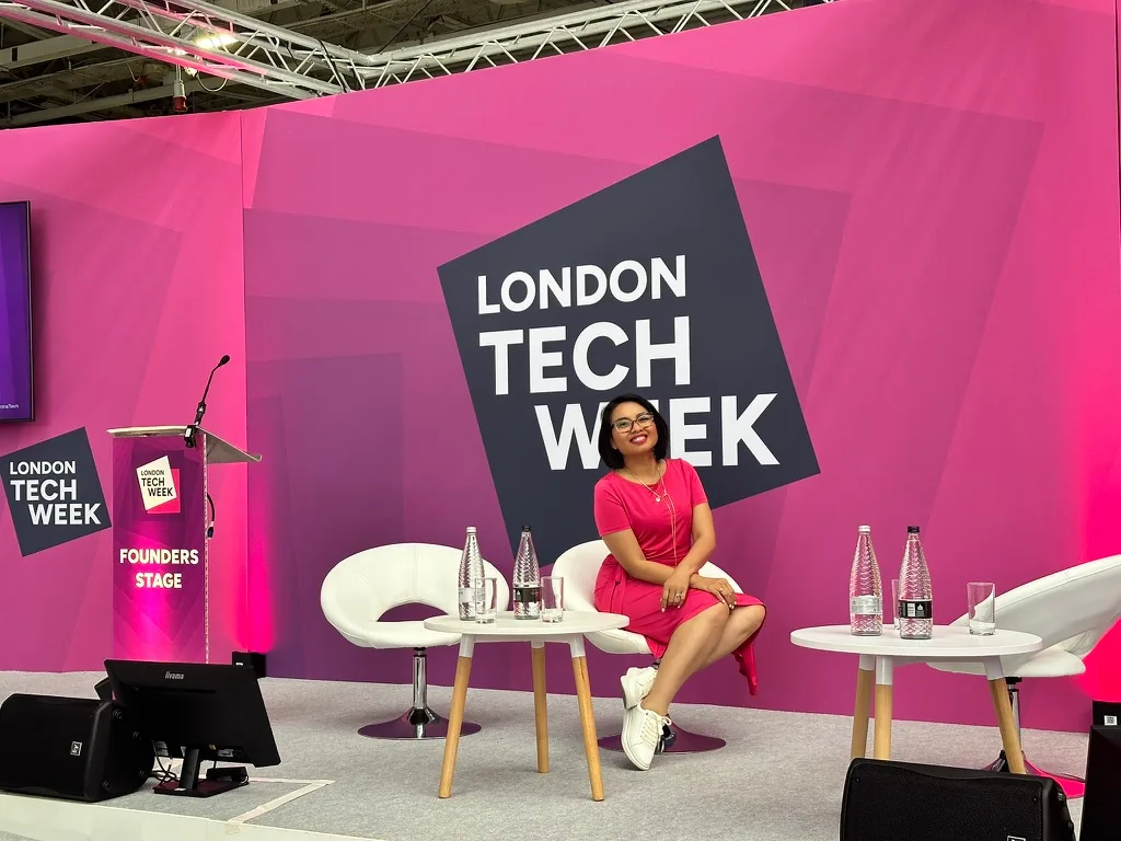 Rebecca seated on stage at London Tech Week